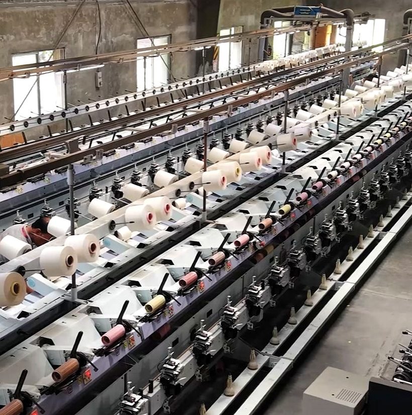 Yarn-winding machines at the Link Up Textiles woven weaving mill, Salem